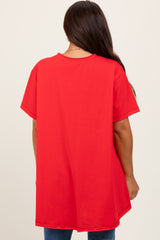 woman wearing a loose-fitting red maternity top, viewed from the back
