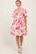 woman wearing a floral print short sleeve dress with a square neckline and a flowy skirt