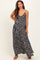 woman wearing a black floral maternity maxi dress with spaghetti straps and a flowy silhouette