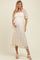 woman wearing a cream floral lace maternity dress and showing her baby bump