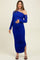 woman wearing a royal blue off-shoulder maternity dress with side slits and holding her baby bump