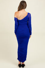 woman wearing a royal blue off-shoulder maternity dress with ruched detailing and long sleeves