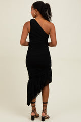 woman wearing a black one-shoulder ruched dress with a ruffled hem.
