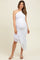 woman wearing a white one-shoulder maternity dress with ruching and asymmetrical hemline