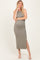 woman wearing a green ribbed maternity maxi dress with a side slit and showing her baby bump
