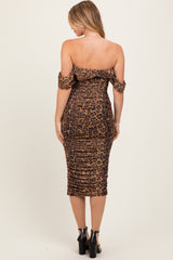 woman wearing a leopard print off-the-shoulder bodycon dress with ruched details and a midi length