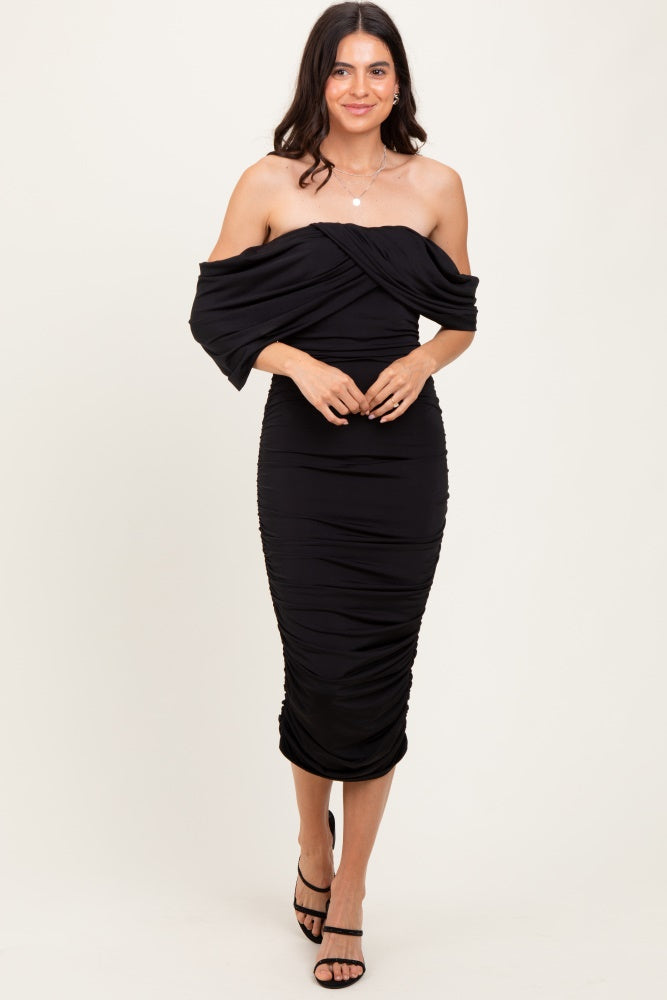 woman wearing a black off-shoulder fitted midi dress with ruched detailing