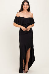 woman wearing a black off-the-shoulder dress with a ruffled top and high-low hemline