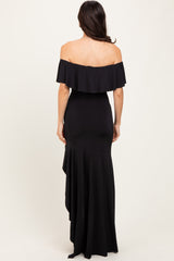 woman wearing a black off-the-shoulder mermaid gown with a ruffled neckline and shaped hemline, shown from the back