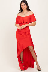 woman wearing a red off-the-shoulder dress with ruffle details and a high-low hemline