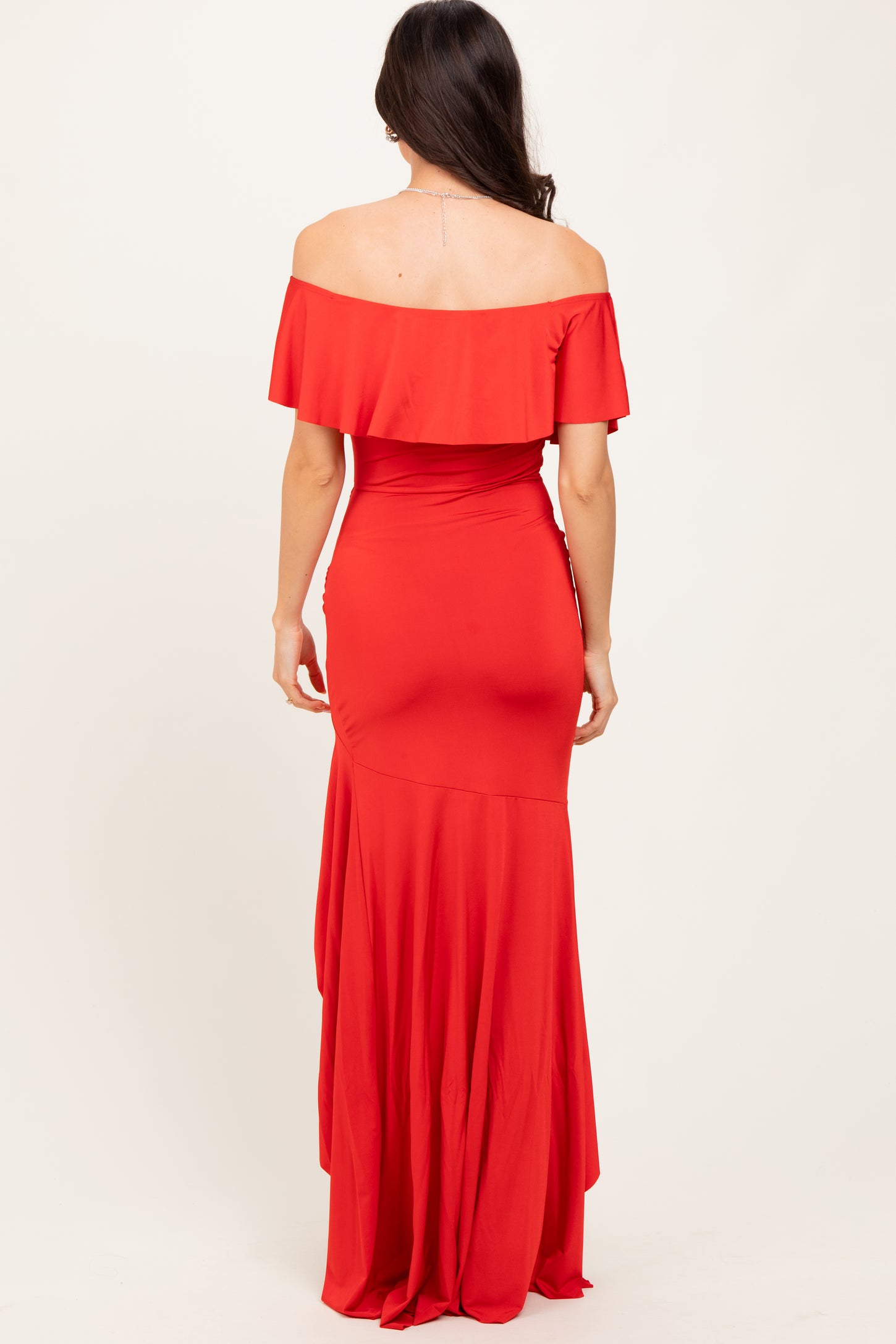 woman wearing a red off-the-shoulder long gown with a flowy skirt from the back