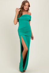 woman wearing a green off-the-shoulder gown with ruching and a thigh-high slit