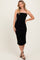 woman wearing a black ruched midi dress with spaghetti straps and a form-fitting silhouette