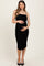 woman wearing a black ruched maternity dress with spaghetti straps and holding her baby bump