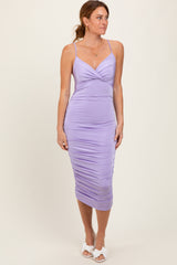 woman wearing a lilac bodycon midi dress with ruching details and thin straps