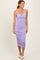 woman wearing a lilac bodycon midi dress with ruching details and thin straps