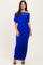 woman wearing a royal blue off-the-shoulder ruched maxi dress with a fitted silhouette and strappy heels