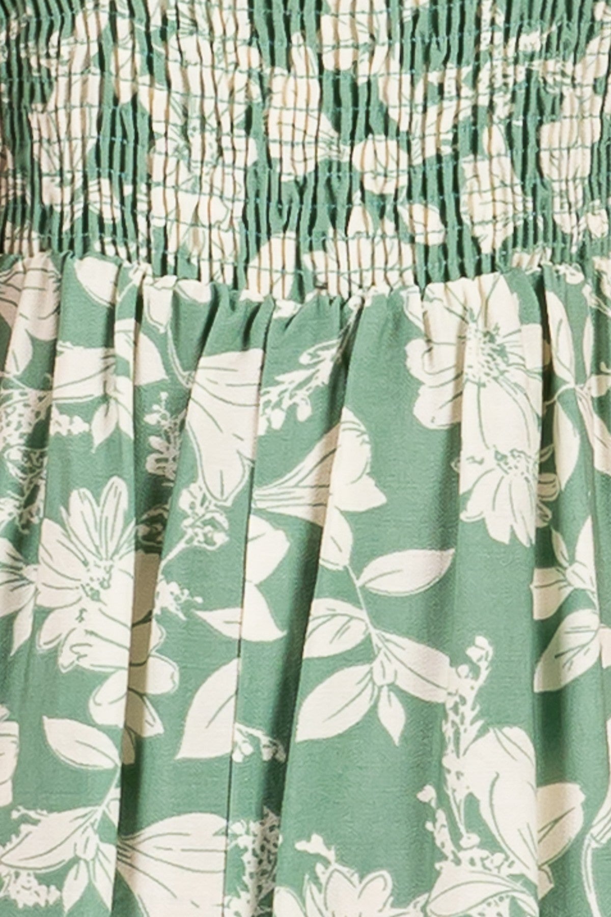 green floral smocked dress with white floral print and pleated skirt detail