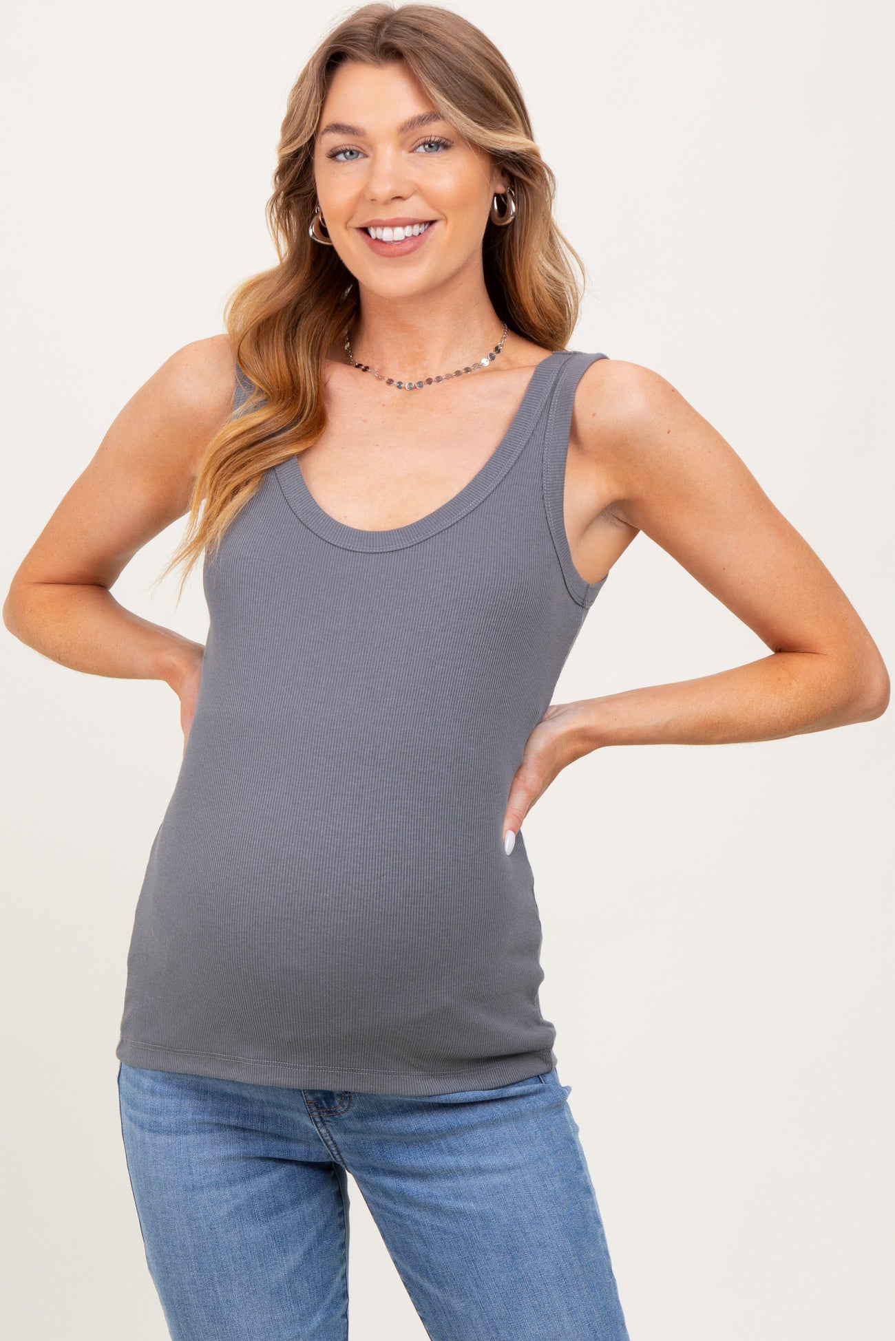 woman wearing a gray ribbed maternity tank top and showing her baby bump
