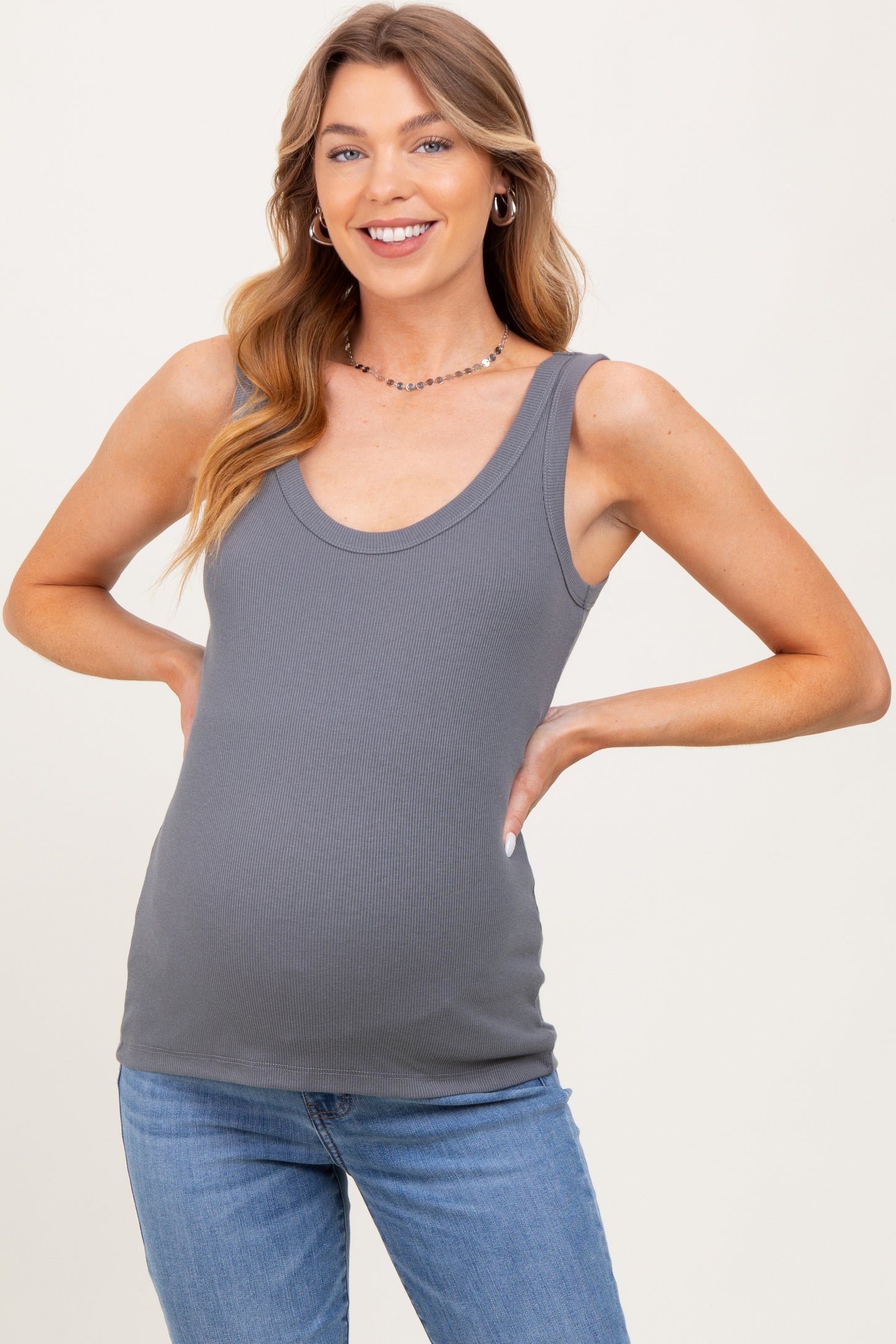 woman wearing a gray ribbed maternity tank top and showing her baby bump