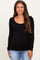 woman wearing a black long sleeve maternity top with a scoop neckline and baby bump visible