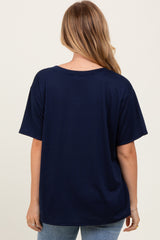 woman wearing a navy blue oversized t-shirt, viewed from the back, paired with light blue jeans