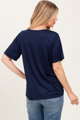 woman wearing a navy blue short sleeve maternity top, showing the back view with relaxed fit