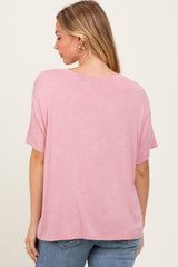 woman wearing a pink relaxed fit short sleeve top, showing the back view with casual style and soft fabric