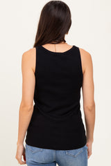 woman wearing a black ribbed tank top with a fitted silhouette, showing the back view and paired with blue jeans