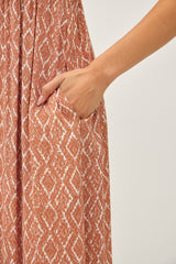 dress with an intricate geometric pattern in rust color featuring a side pocket