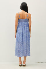 woman wearing a blue patterned maxi dress with spaghetti straps and a smocked back detail