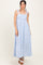 woman wearing a light blue plaid maxi dress with tie shoulder straps and a smocked bodice