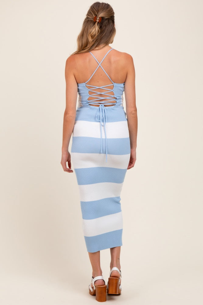 woman wearing a blue and white striped maternity dress with a back lace-up detail and a fitted silhouette