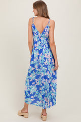 woman wearing a blue floral maxi dress with a v-back and adjustable straps, shown from the back