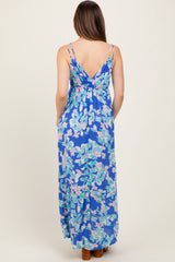 woman wearing a floral print blue maternity maxi dress with adjustable straps, showing smooth back design