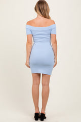 woman wearing a light blue off-shoulder fitted mini dress with short sleeves