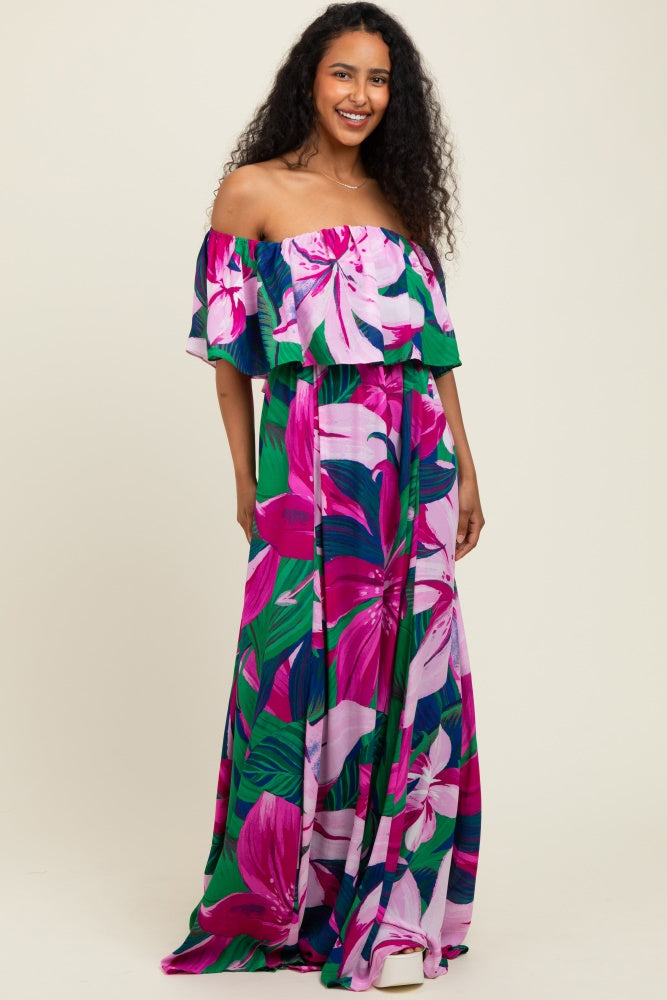 woman wearing a pink and green floral off-the-shoulder maxi dress with ruffle details
