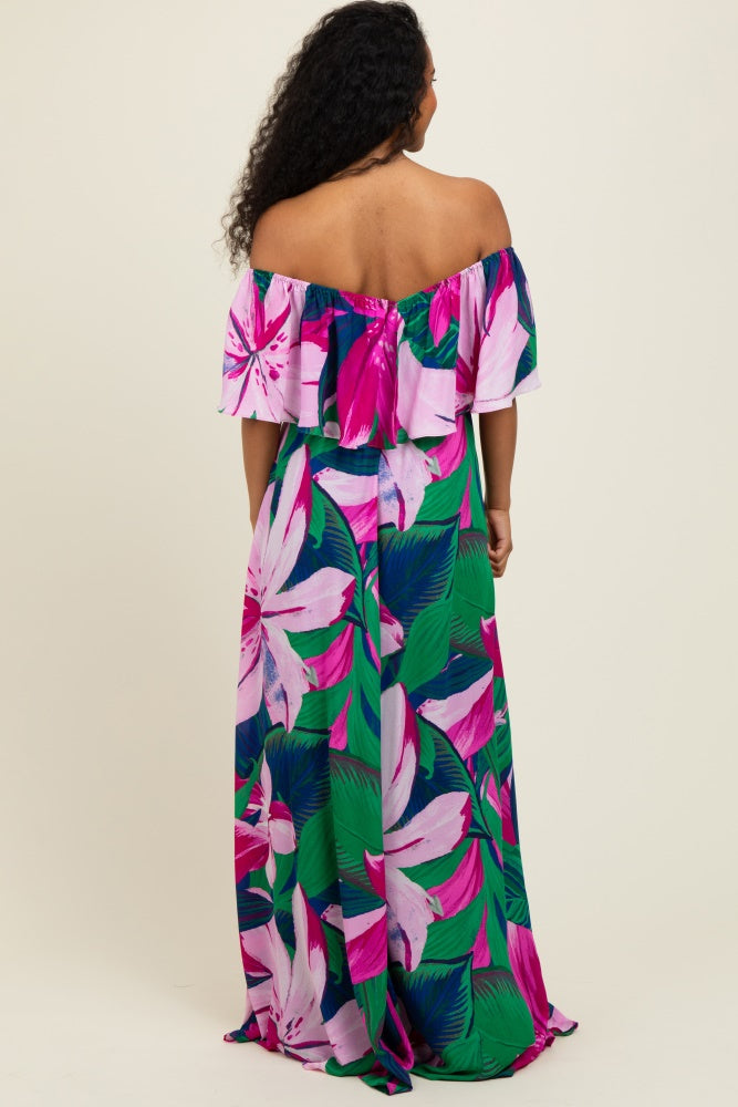 woman wearing a vibrant off-the-shoulder maxi dress with pink and green floral print, shown from the back