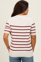 woman wearing a cream and burgundy striped maternity top, showing a relaxed fit and short sleeves from the back