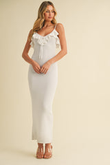 woman wearing a white ribbed maxi dress with ruffle details and adjustable straps