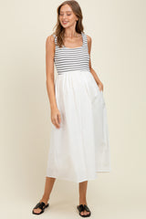 woman wearing a striped maternity dress with a white skirt and pockets, featuring a fitted bodice and flowing design
