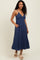 woman wearing a navy blue striped maxi dress with a deep v-neckline and pockets, styled with platform sandals