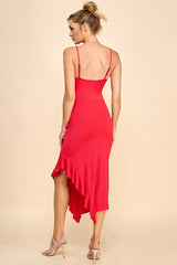 woman wearing a red spaghetti strap dress with a ruffled high-low hem and open back styling