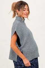 woman wearing a gray ribbed maternity sweater with short sleeves and a visible baby bump