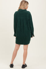 woman wearing a green corduroy long sleeve shirt dress, showing the back view with a relaxed fit and button details on the sleeves