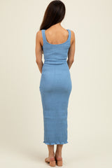 woman wearing a light blue smocked maxi dress with a fitted silhouette and ruffled hem, viewed from the back