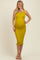 woman wearing a mustard yellow maternity dress with a fitted silhouette and ruffled hem, showing her baby bump