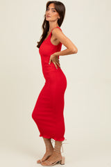 woman wearing a fitted red ribbed midi dress with a scalloped hem and strappy beige heeled sandals