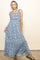 woman wearing a blue floral maxi dress with ruffle straps and a tiered skirt