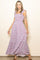 woman wearing a lavender floral maxi dress with ruffled straps and a flowing skirt